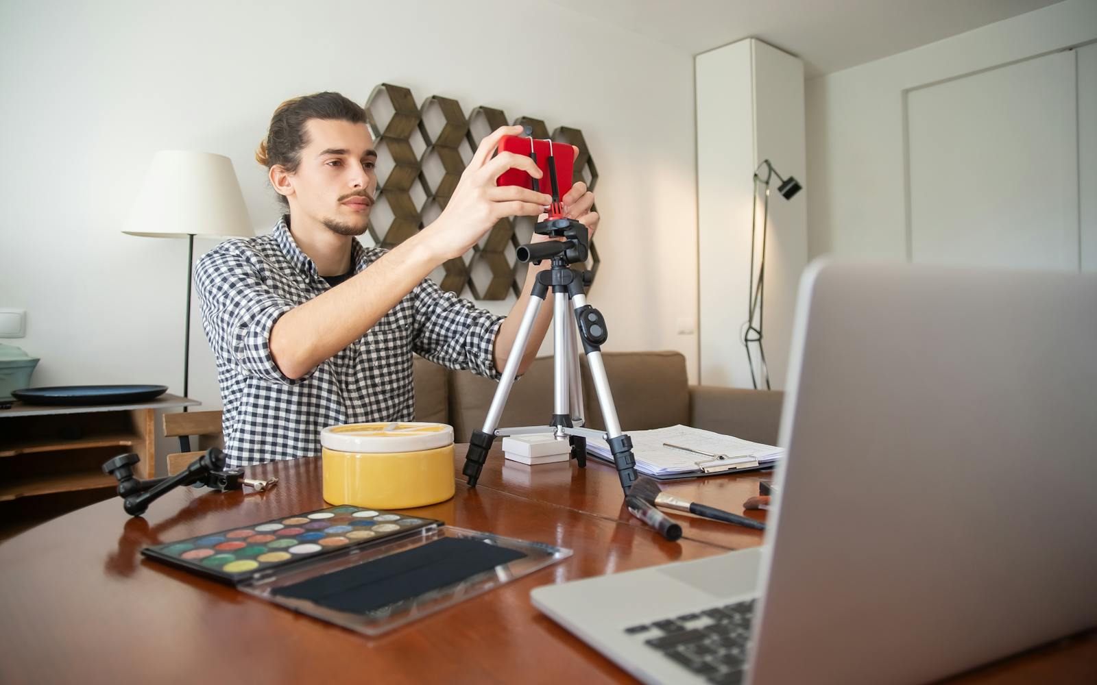 Young content creator setting up a phone on a tripod