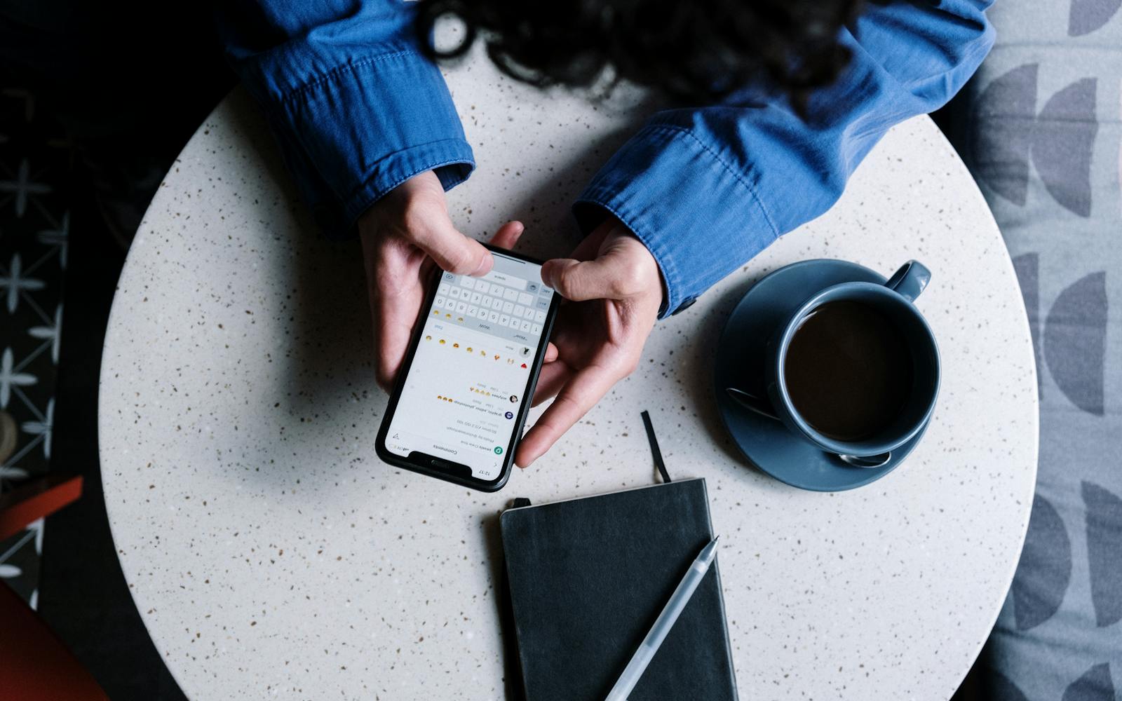Customer using their smartphone at a cafe